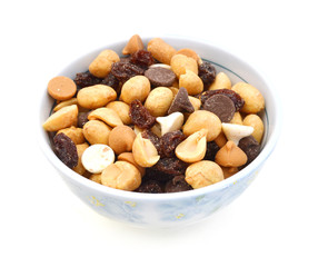 Mix nuts, dry fruits and grapes in white bowl on a white background