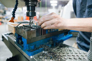 man operating vertical mill machine