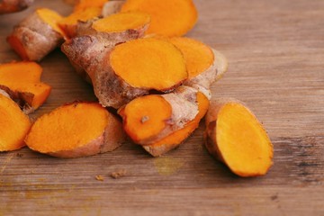 Fresh turmerric on wood background