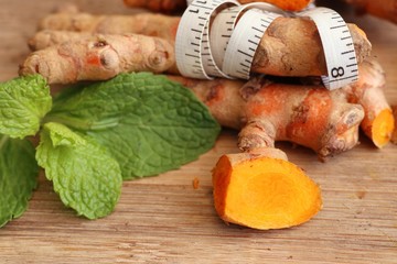 Fresh turmerric on wood background