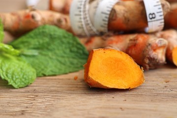 Fresh turmerric on wood background