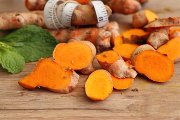 Fresh turmerric on wood background