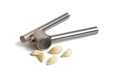 Garlic press and garlic cloves