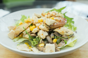 Plates with chicken salad on the table