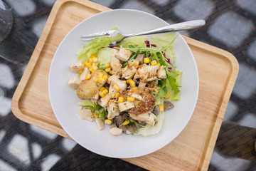 Plates with chicken salad on the table