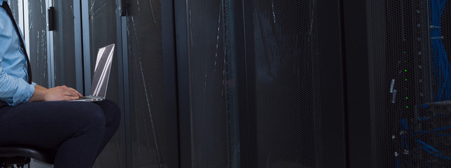engineer working on a laptop in server room