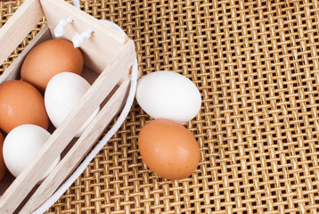 Brown eggs on wooden background