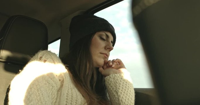 Pretty woman sleeping in car