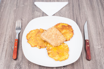 Fried plantain toston (patacon) with fried cheese