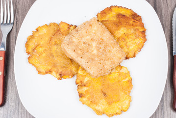 Fried plantain toston (patacon) with fried cheese