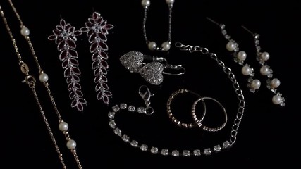 Assorted miscellaneous luxury jewelry on a spinning/rotating demonstration table - Powered by Adobe