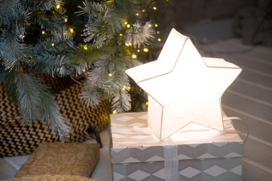 The lamp is the star on a Christmas present under the tree and glow in the interior