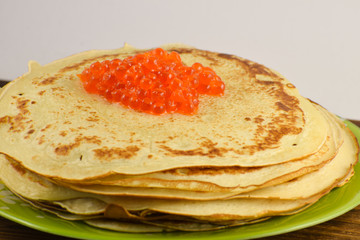 Traditional Russian pancakes with red caviar