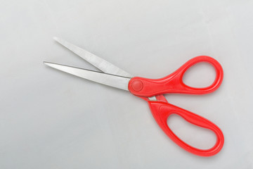 Red scissors isolated white background.