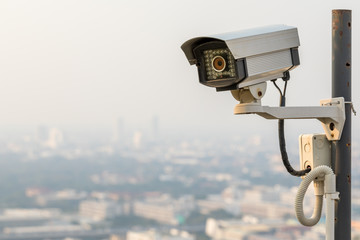 Security CCTV camera in cityscape with sunset at Bangkok, Thailand