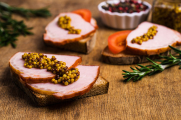 Sandwich with smoked meat and mustard