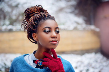 Portrait of African women in a vintage style in winter on snow background close-up outdoor