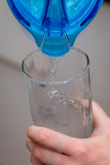 Pouring out cold water into a cup