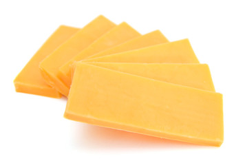 Cheddar cheese slices on white background.