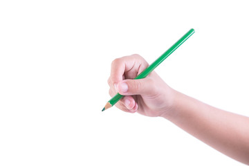 A woman holding a green pencil with her right hand and writing on a white background.