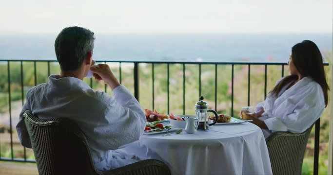 Couple enjoying beautiful healthy breakfast at luxury hotel