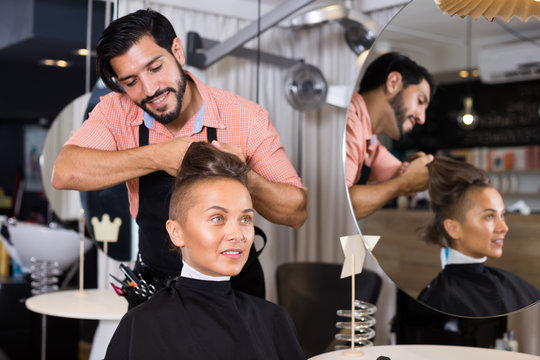 man hairdresser making hairstyle for woman
