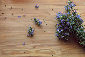 Close up, top shot of fresh Mediterranean herbs bouquet, rosemary on rustic wooden table, selective focus, space for text, minimal food style concept