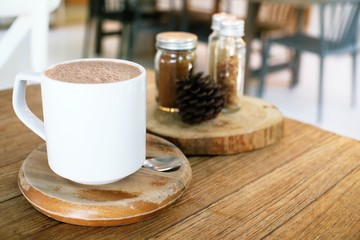 Cup of hot coffee on wooden table.