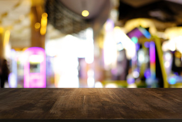 Empty wood table top and blur of night market background/selective focus .For montage product display.