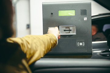 man pass underground parking barrier