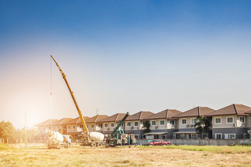 Fototapeta premium House building at construction site with crane truck