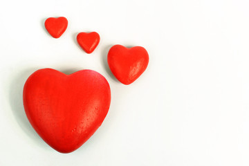 A red hearts of different sizes isolated on white background