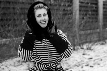 Happy and smiling woman on weekend. Lady in a striped coat walks on the street enjoying fresh air...
