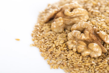 Closeup of flaxseed and walnut on white background.