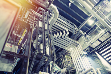 Equipment, cables and piping as found inside of a modern industrial power plant
