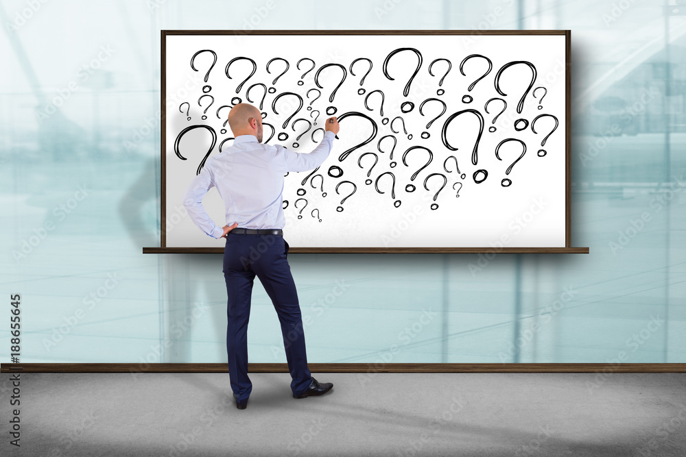Poster view of a businessman in front of a wall trying to find find answers - daily life concept