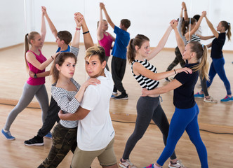 Teenagers dancing of partner dance in studio