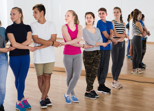 Teenagers dancing folk dance  in school
