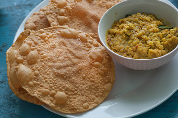 Colorful table with Indian food for breakfast. Papadum bread and vegetarian dal made from lentils or beans. Also popular in Nepalese, Pakistani, Sri Lankan and Bangladeshi cuisines