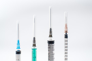 Syringes on white different sizes