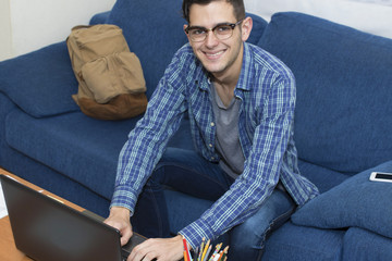 Fototapeta premium young adult working or studying with the computer at home