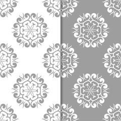 White and gray floral backgrounds. Set of seamless patterns