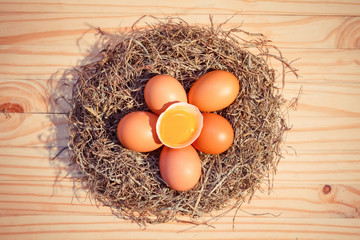 Chicken eggs in a nest on wooden, Top view