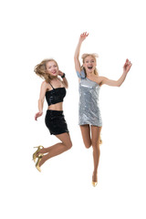 2 beautiful happy girls are jumping in the studio on a white background isolated. the joy of shopping. freezing jump - the flight of girls.