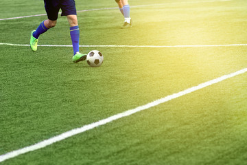 Closeup of a soccer ball and soccer player at the stadium.