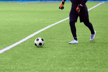 Closeup of a soccer ball and soccer player at the stadium.