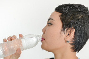 Smart Asian woman drinking a bottle of water, healthy concept.