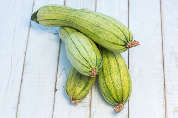 green zucchini on a old wooden board