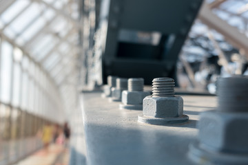 Metal construction of modern pedestrian footbridge. Detail with rivets and screws. Abstract...