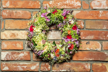 a beautiful flower wreath isolated on a Brick wall background